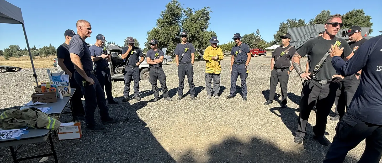 Operators gathered in an open field for a hands-on recovery and gear briefing.